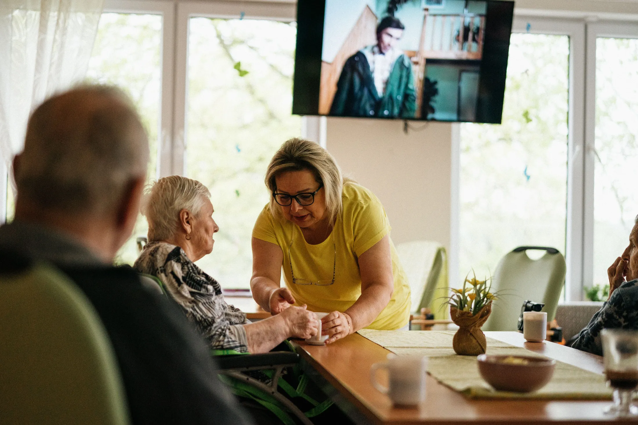 A caregiver spending time with seniors during an in-home visit