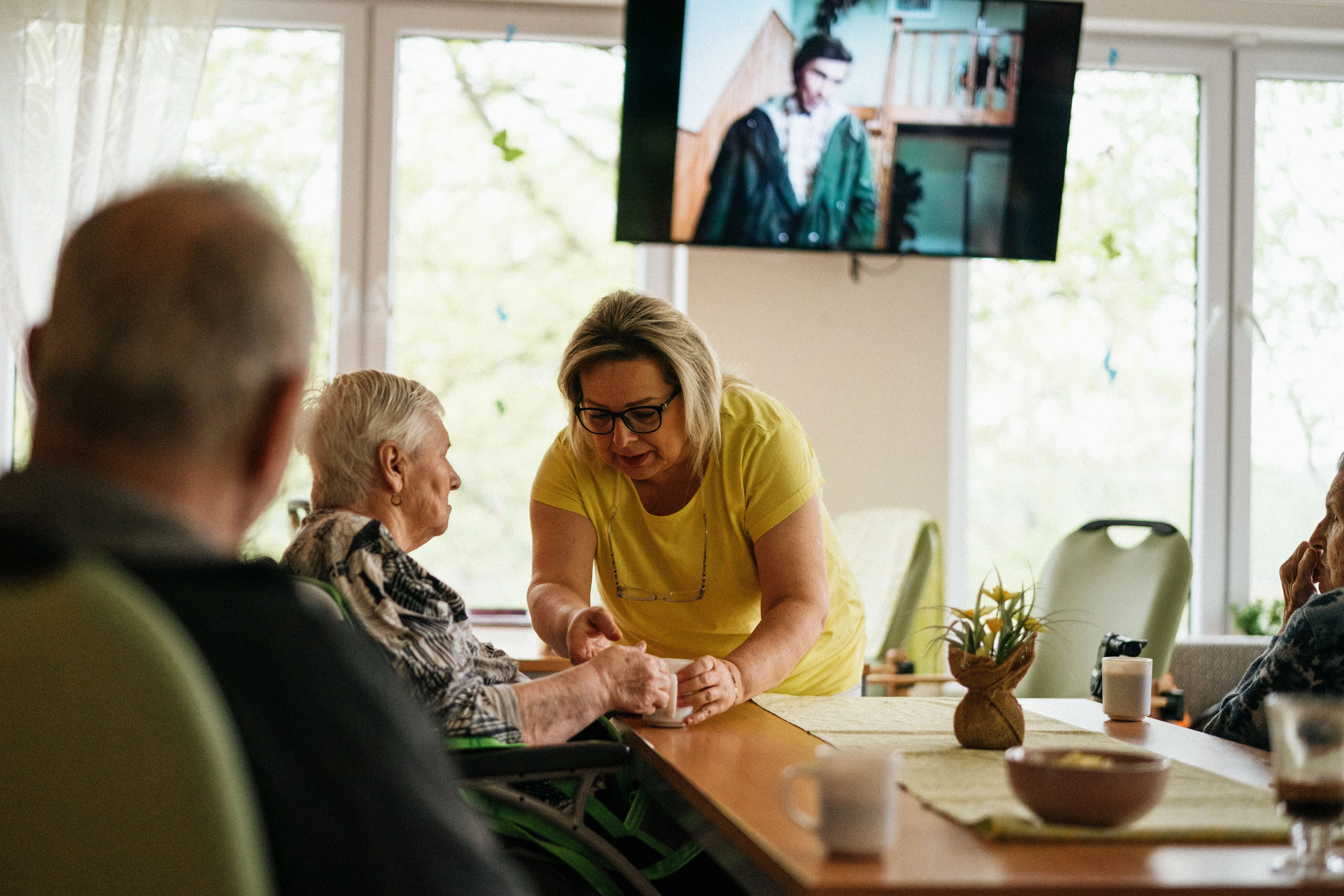 A caregiver spending time with seniors during an in-home visit