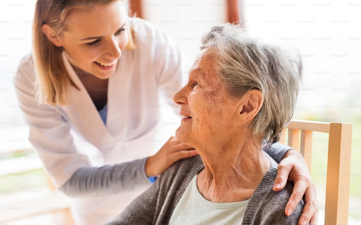 Caregiver talking with a senior woman at home