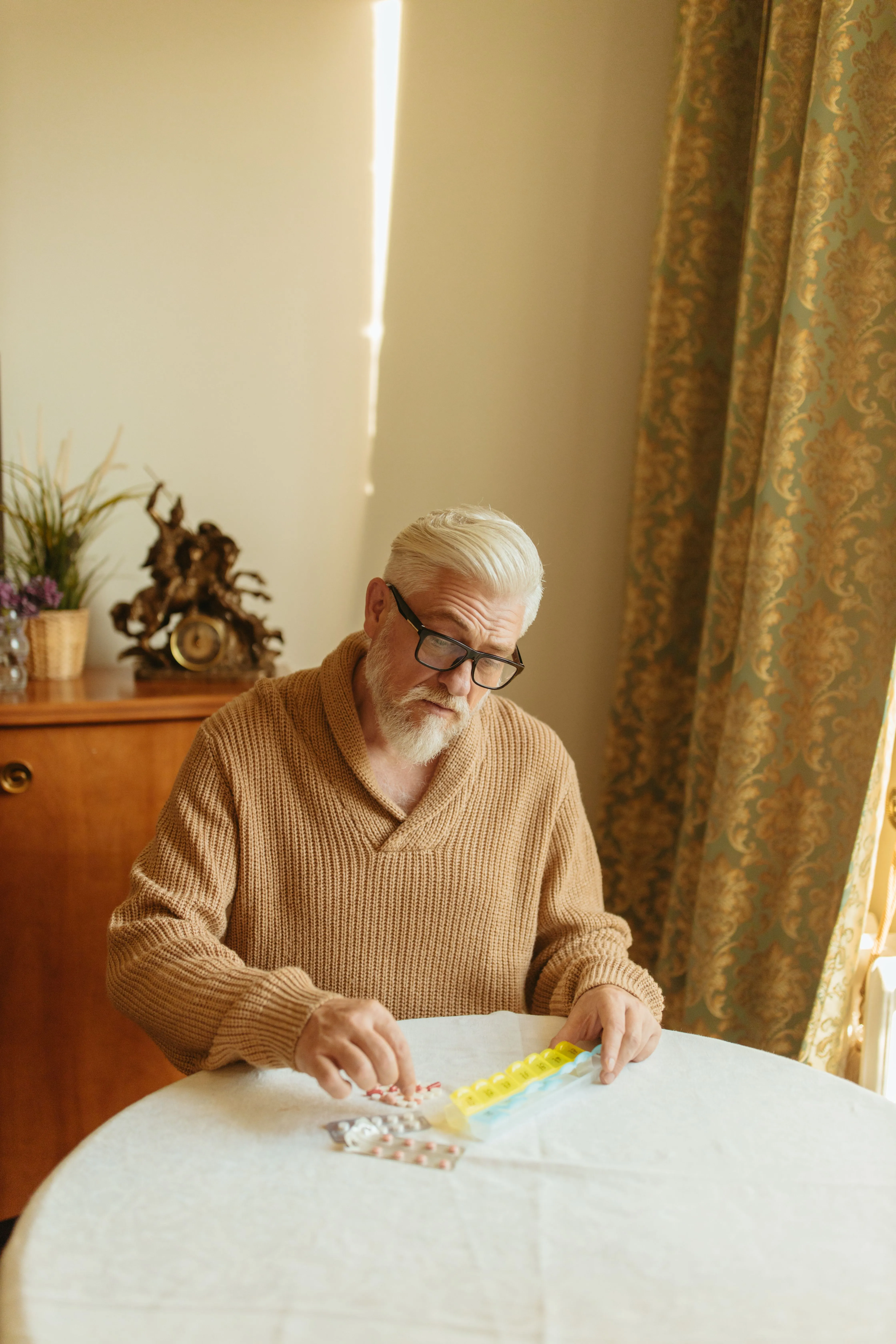 Senior man sorting his medication at home